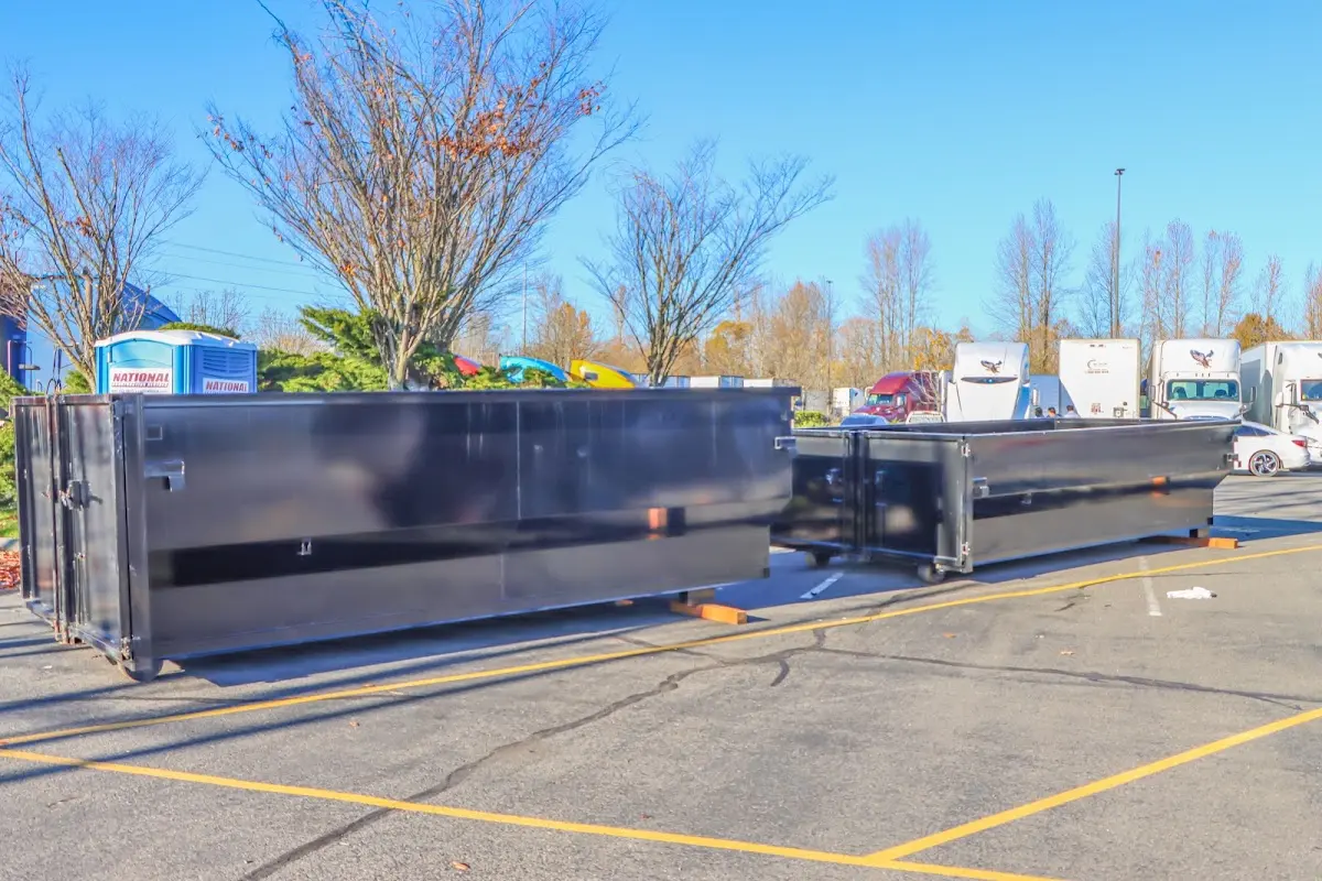 Professional dumpster rental service with roll-off container on residential driveway in Stevens Point